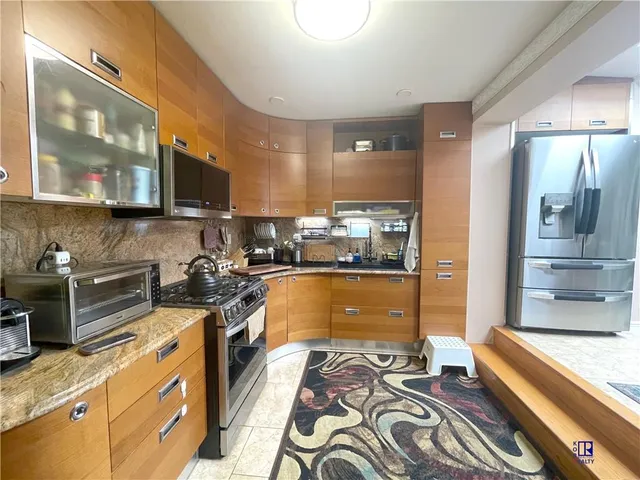 a kitchen with a stove a sink and a refrigerator