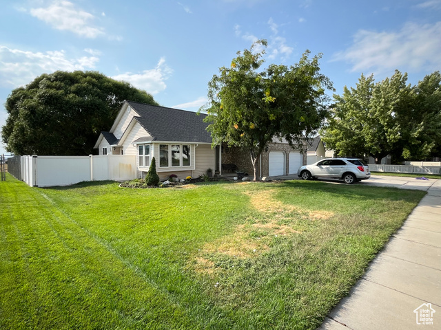2548 South 700 West Perry, UT 84302 - Photo 14 of 18 View of front of house featuring concrete driveway, a shingled roof, and a garage