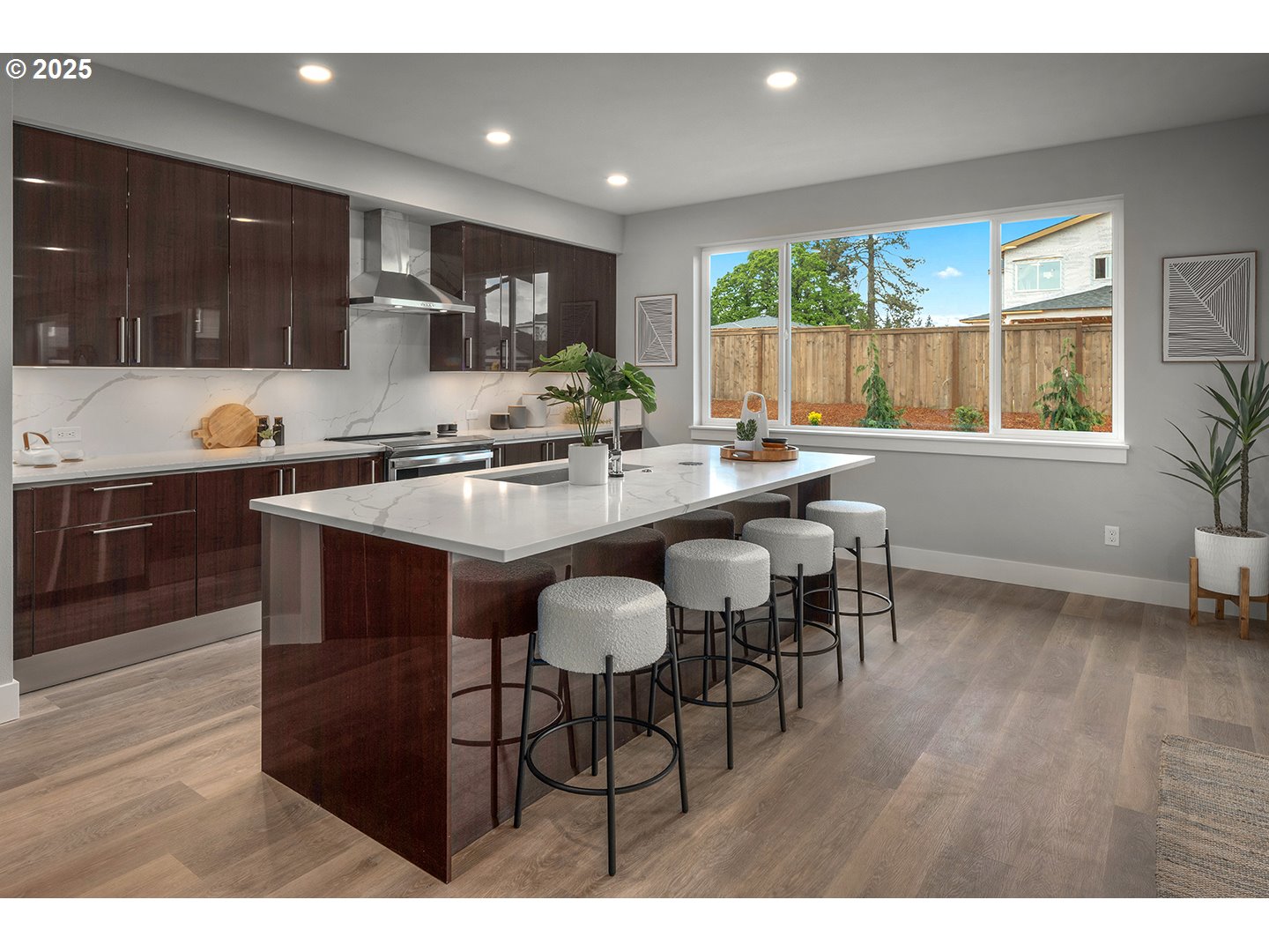 7083 Southwest Alder Lane Wilsonville, OR 97070 - Photo 11 of 35 a kitchen with stainless steel appliances granite countertop wooden cabinets a stove a sink a dining table and chairs