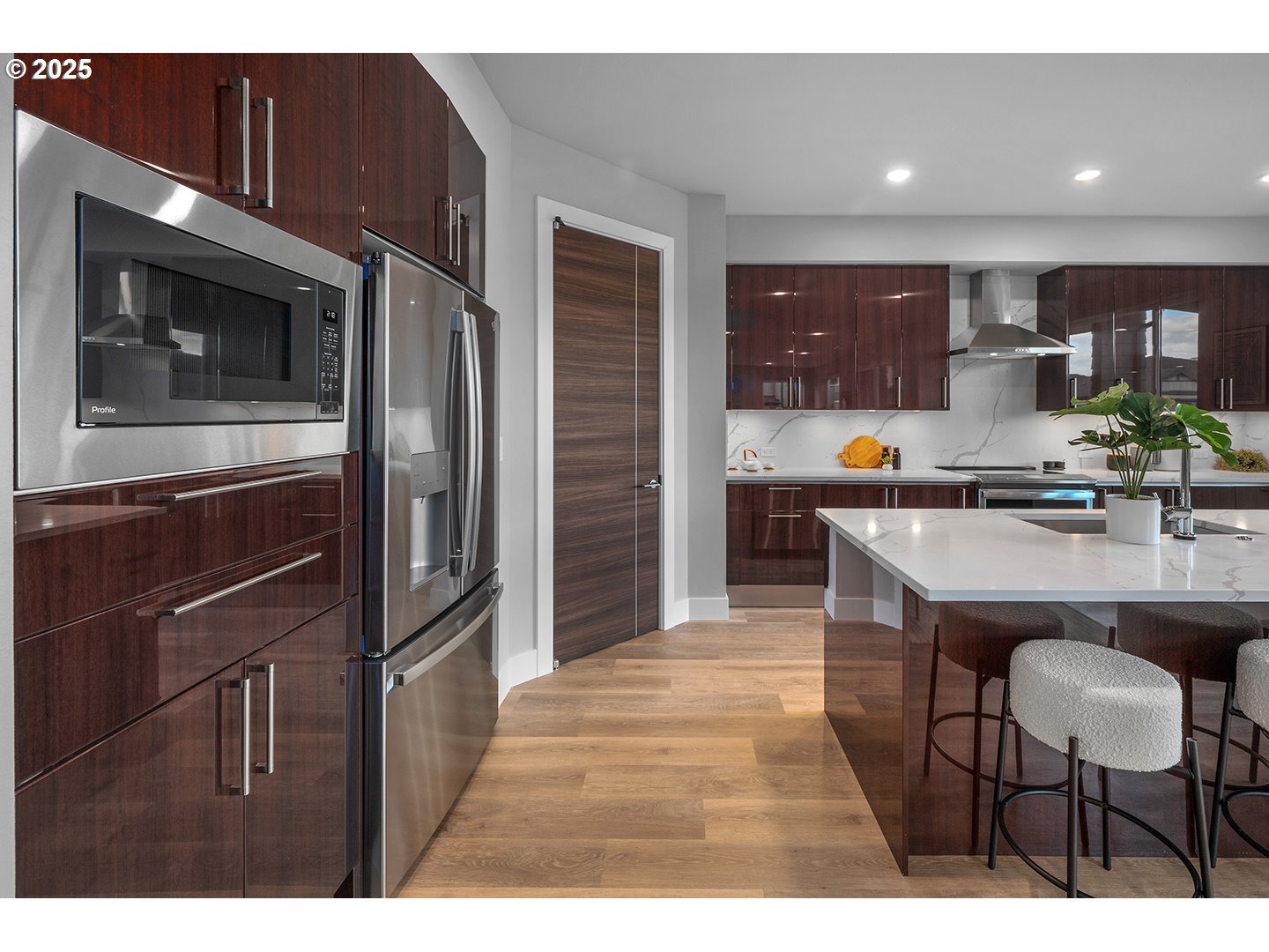 7083 Southwest Alder Lane Wilsonville, OR 97070 - Photo 13 of 35 a kitchen with stainless steel appliances kitchen island granite countertop a refrigerator and a stove top oven