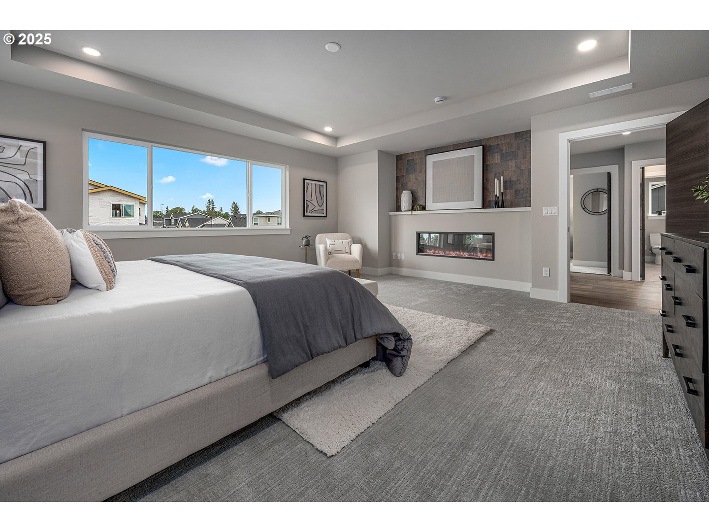 7083 Southwest Alder Lane Wilsonville, OR 97070 - Photo 22 of 35 a bedroom with a large bed and a view of living room