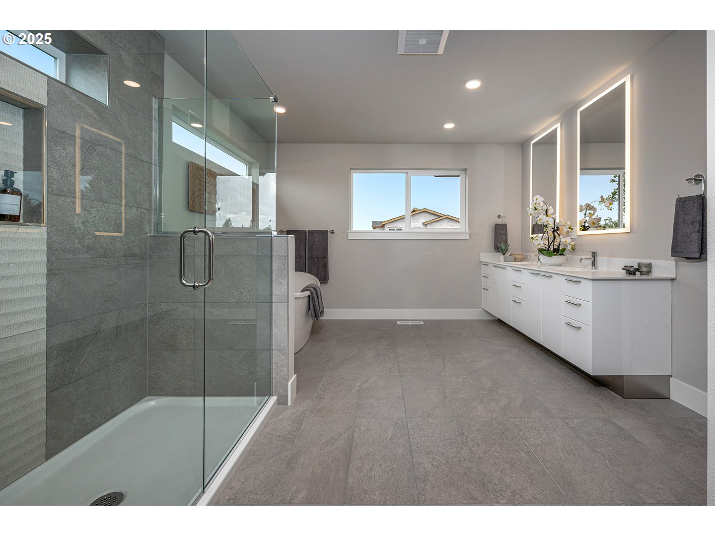7083 Southwest Alder Lane Wilsonville, OR 97070 - Photo 25 of 35 a bathroom with a double vanity sink a mirror and a shower