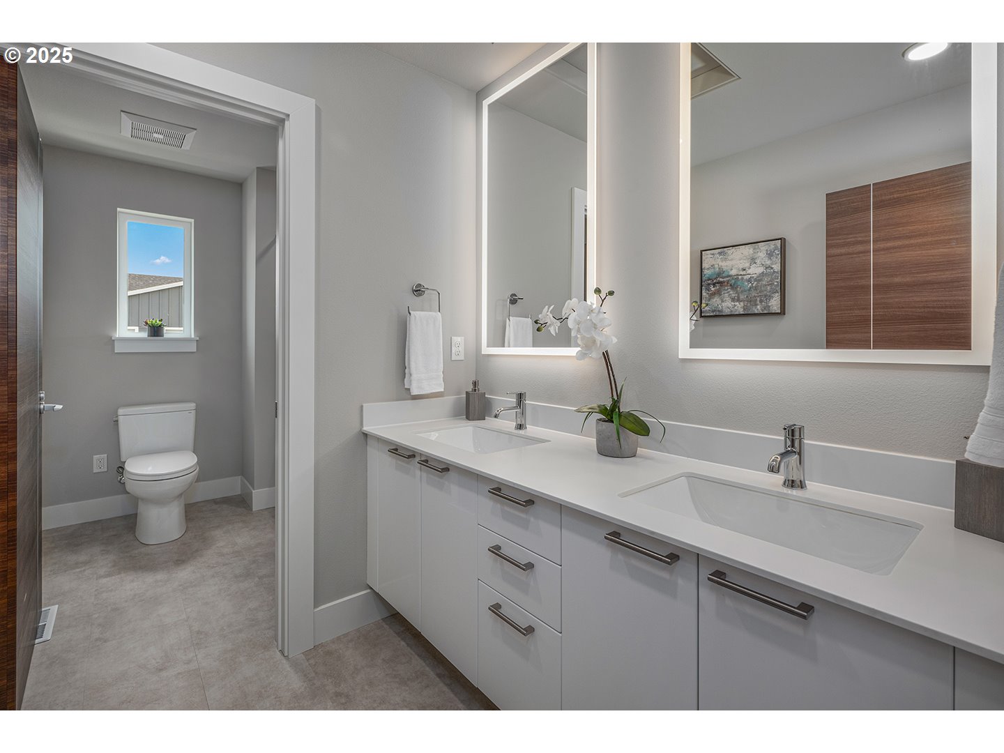 7083 Southwest Alder Lane Wilsonville, OR 97070 - Photo 28 of 35 a bathroom with a double vanity sink a toilet and a mirror