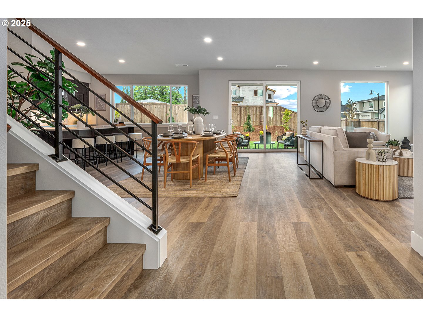 7083 Southwest Alder Lane Wilsonville, OR 97070 - Photo 5 of 35 a view of a living room and entryway with wooden floor