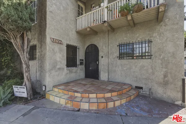 a brick building with a bench in front of it