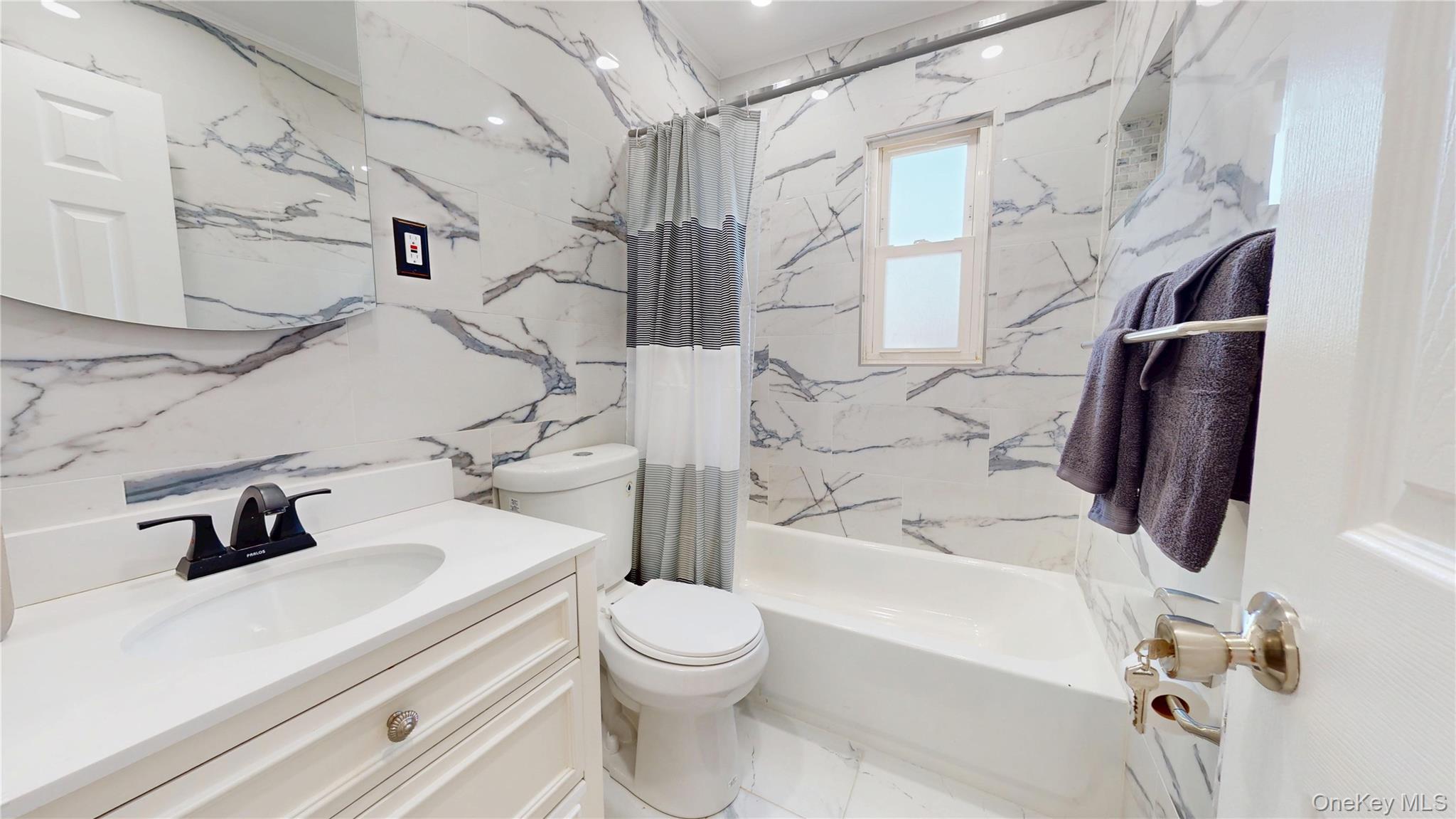 219-42 141st Road Queens, NY 11413 - Photo 5 of 23 a bathroom with a sink a toilet and shower
