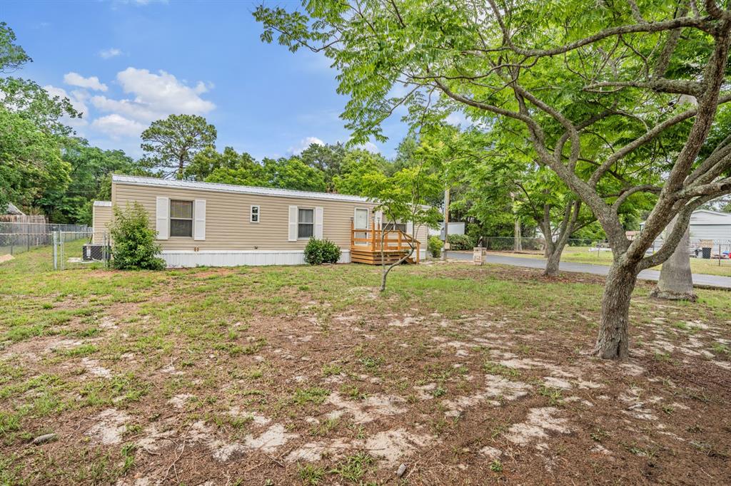 9739 Ray Street Hudson, FL 34669 - Photo 36 of 36 a backyard of a house with plants and large tree