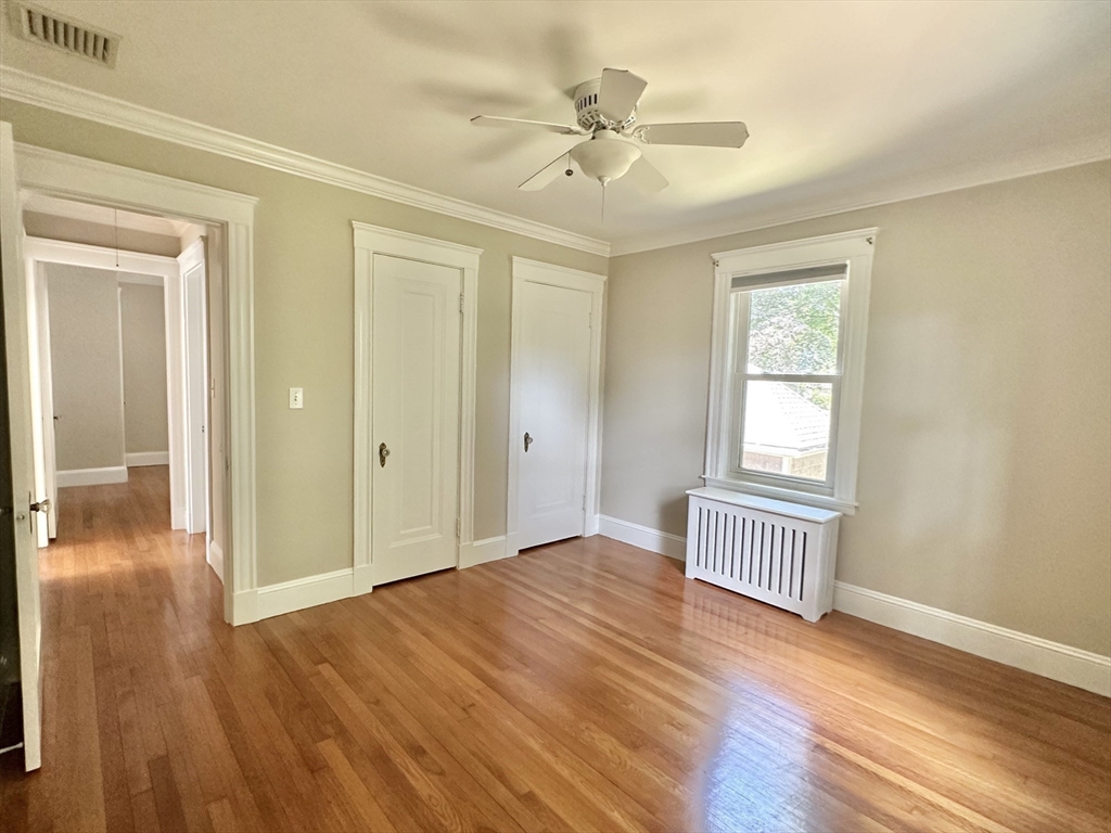 8 A Mellon Road Wellesley, MA 02482 - Photo 9 of 22 wooden floor in an empty room with a window