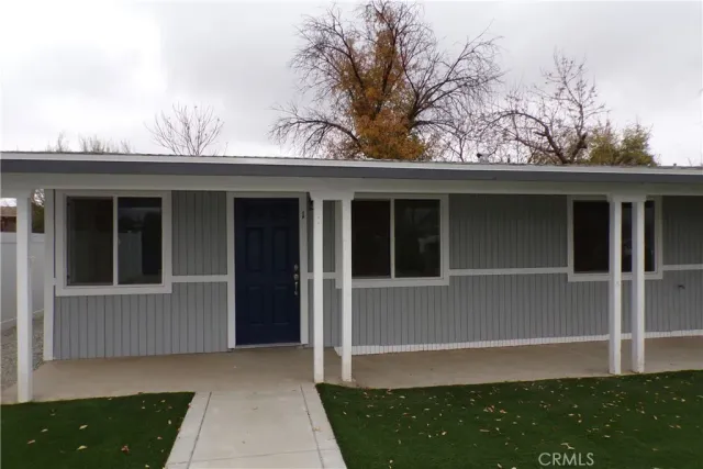 a view of house with backyard