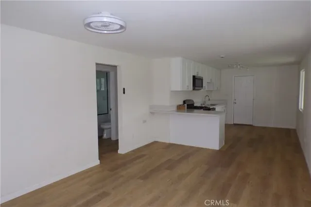 a kitchen with a refrigerator and a stove top oven