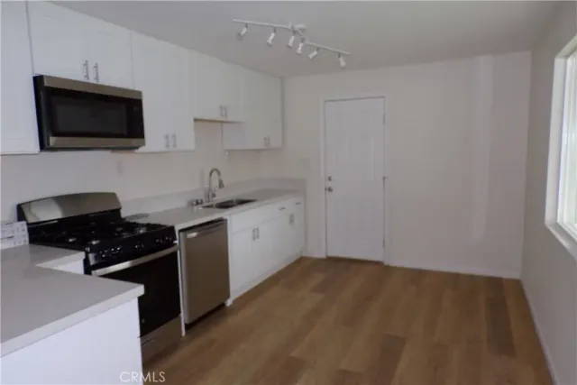 a kitchen with a sink and a stove top oven