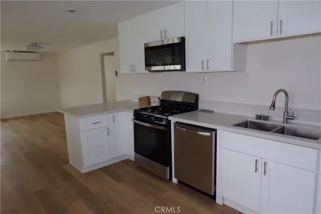 a kitchen with a sink and a stove top oven