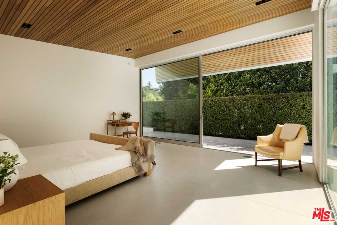 1549 Rising Glen Road Los Angeles, CA 90069 - Photo 11 of 24 a bedroom with a bed chair and window