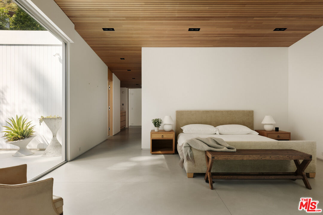 1549 Rising Glen Road Los Angeles, CA 90069 - Photo 13 of 24 a bed sitting in a bedroom next to a window