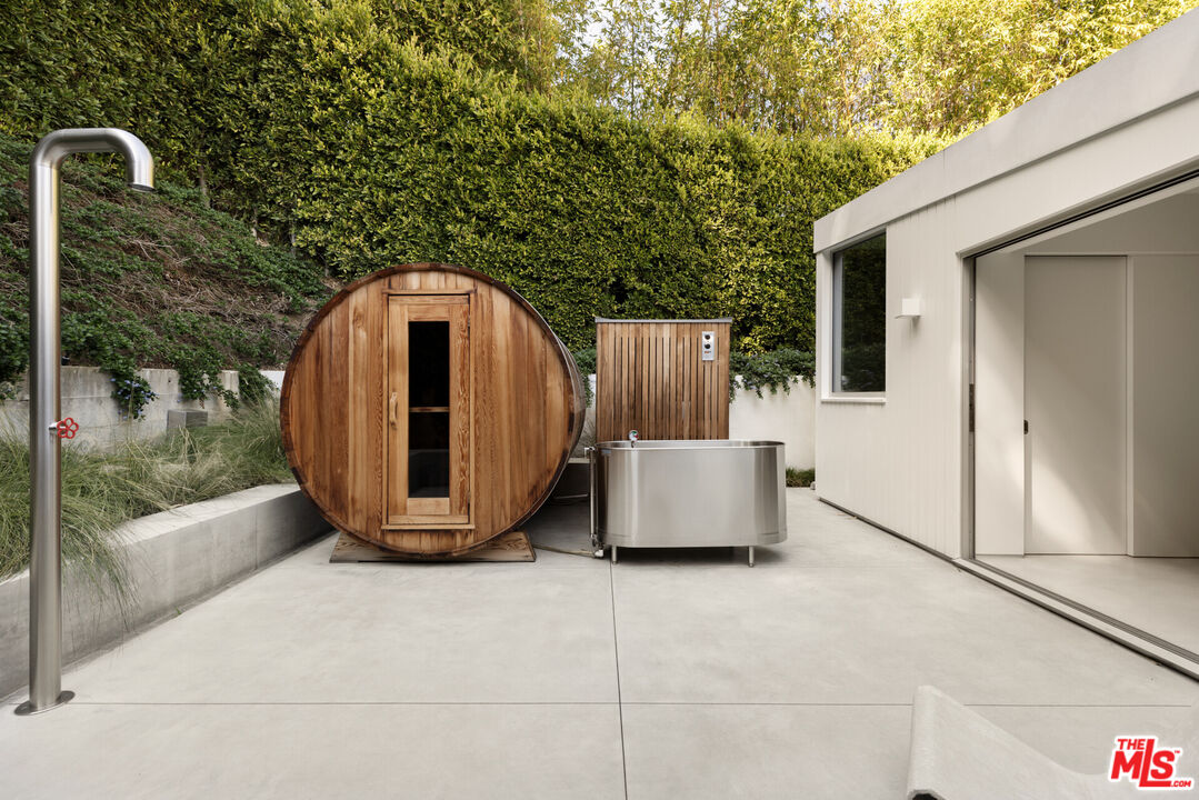 1549 Rising Glen Road Los Angeles, CA 90069 - Photo 17 of 24 a wooden bench sitting in front of a building