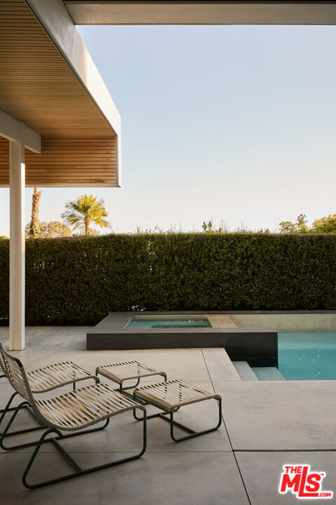 1549 Rising Glen Road Los Angeles, CA 90069 - Photo 18 of 24 a view of swimming pool with seating area and roof