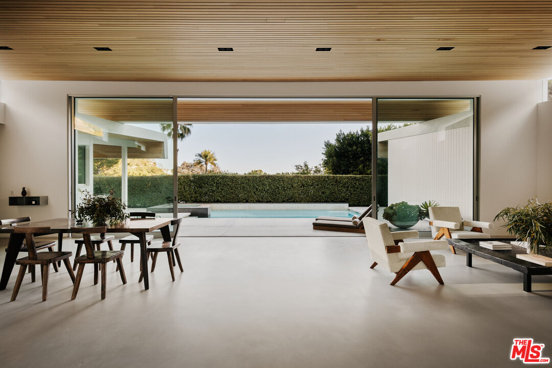 1549 Rising Glen Road Los Angeles, CA 90069 - Photo 4 of 24 a living room with patio furniture and a garden