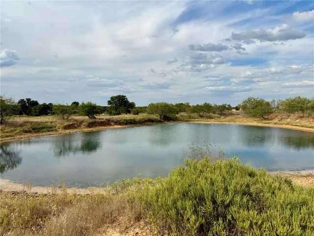 a view of a lake with houses in the back