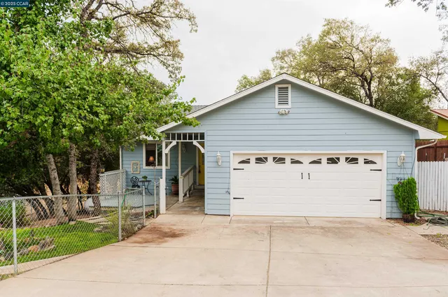a view of a house with a yard and garage
