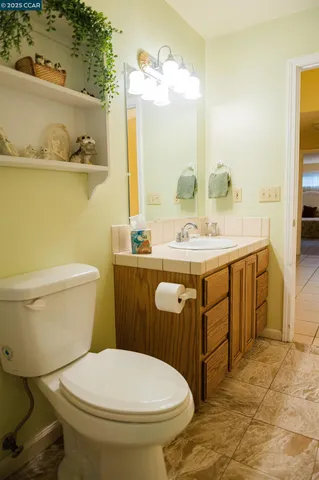 a bathroom with a sink toilet and mirror