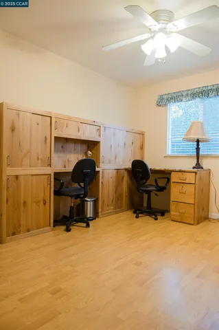 a living room with furniture a flat screen tv and a window