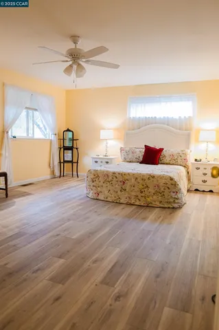 a living room with couch and a ceiling fan