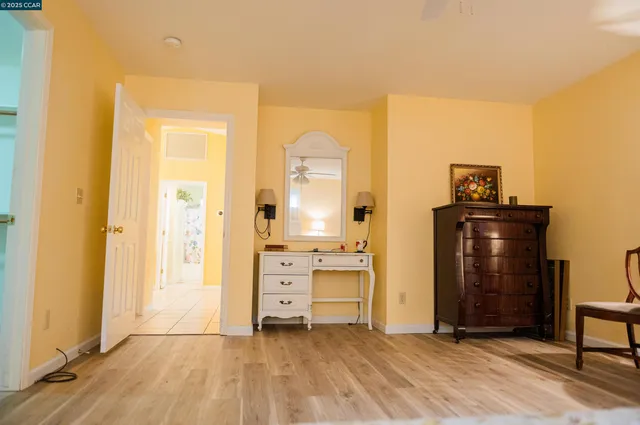 a room with a dresser and mirror