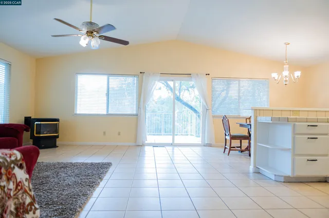 a view of a livingroom with furniture and chandelier fan