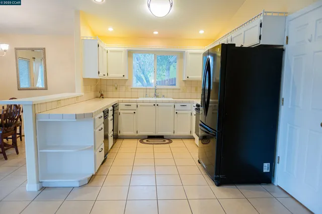 a kitchen with a refrigerator and a sink