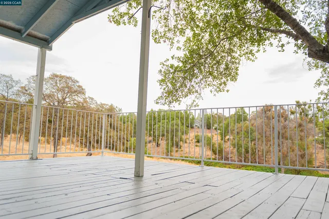 a view of a room with wooden floor and city view