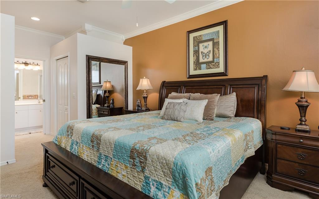 21468 Knighton Run Estero, FL 33928 - Photo 11 of 21 a bedroom with a bed and a lamp on dresser