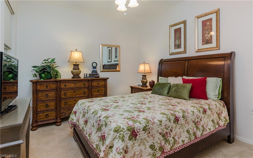 21468 Knighton Run Estero, FL 33928 - Photo 14 of 21 a bedroom with a bed and a dresser