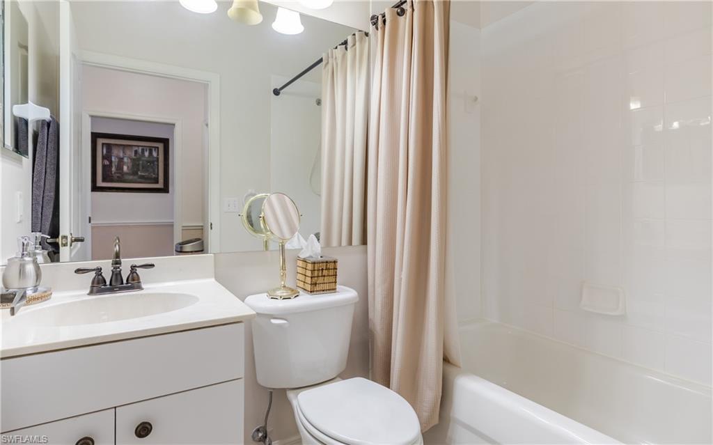 21468 Knighton Run Estero, FL 33928 - Photo 15 of 21 a bathroom with a toilet a sink and a mirror