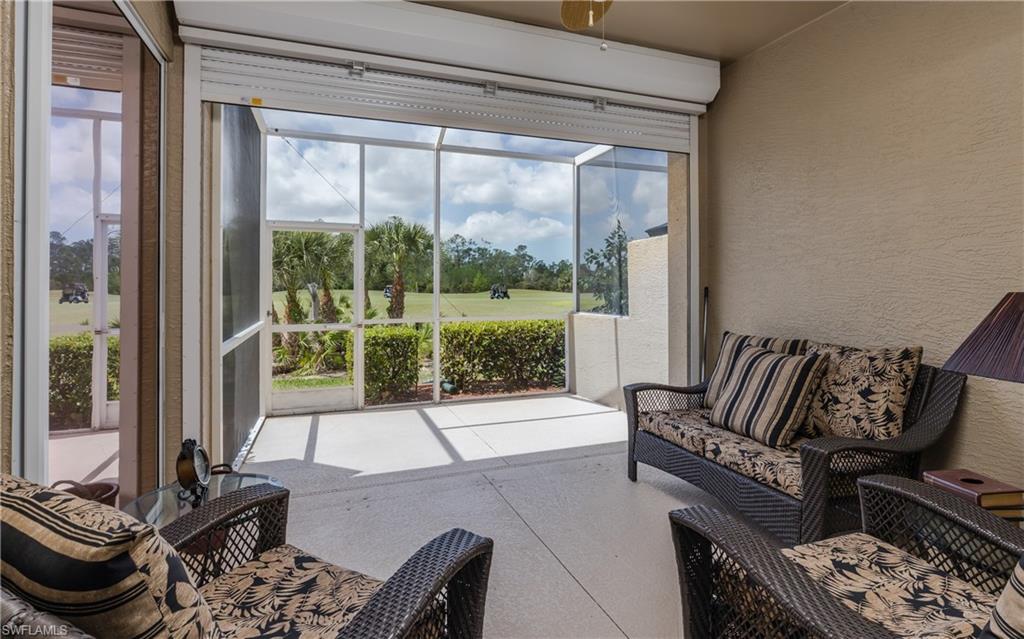 21468 Knighton Run Estero, FL 33928 - Photo 17 of 21 a living room with furniture and a floor to ceiling window