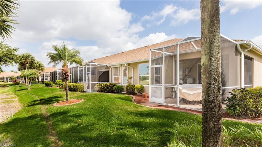 21468 Knighton Run Estero, FL 33928 - Photo 18 of 21 a view of a house with backyard and a tree