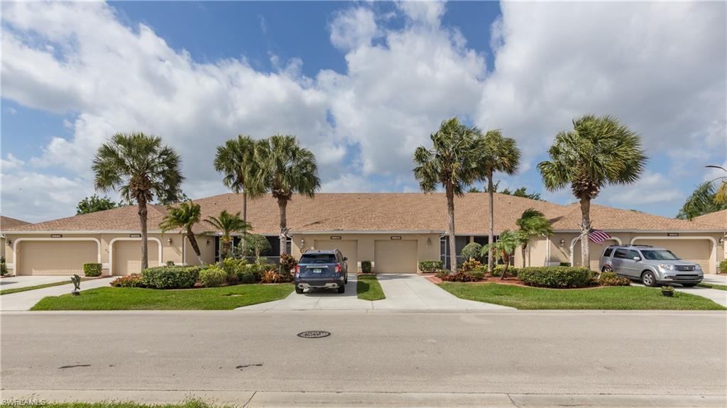 21468 Knighton Run Estero, FL 33928 - Photo 19 of 21 a front view of multiple houses with yard