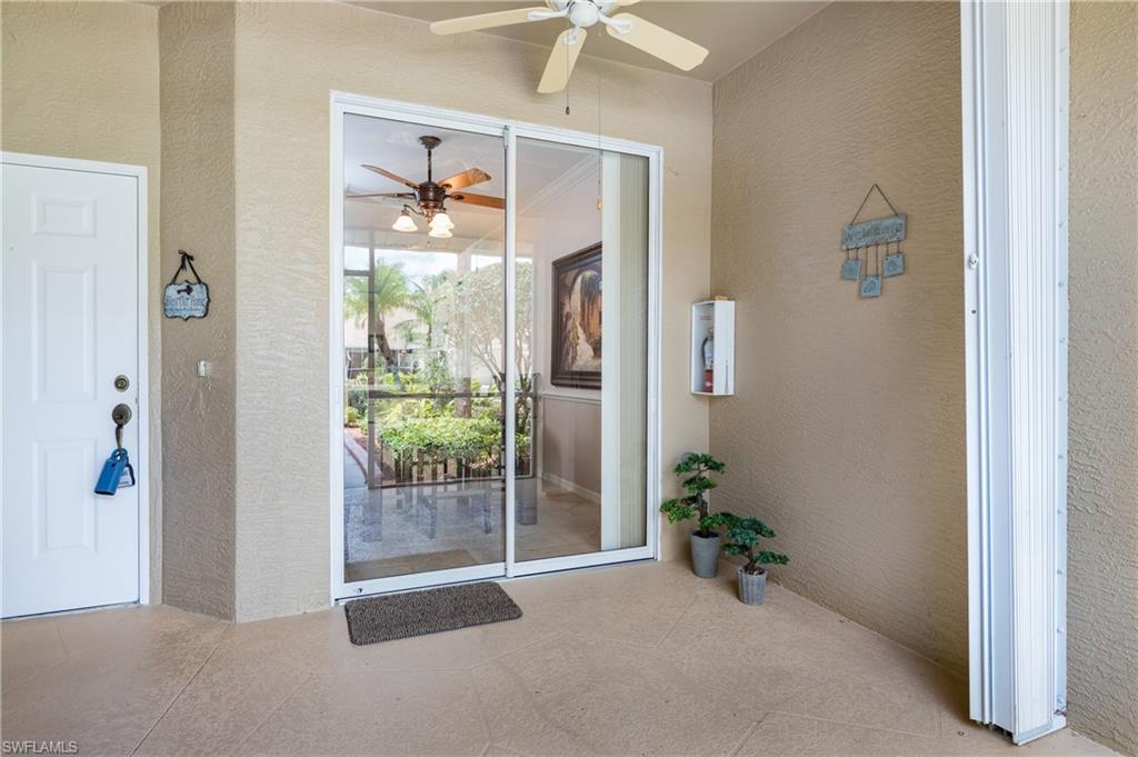 21468 Knighton Run Estero, FL 33928 - Photo 2 of 21 a view of a hallway with wooden floor and a dining room