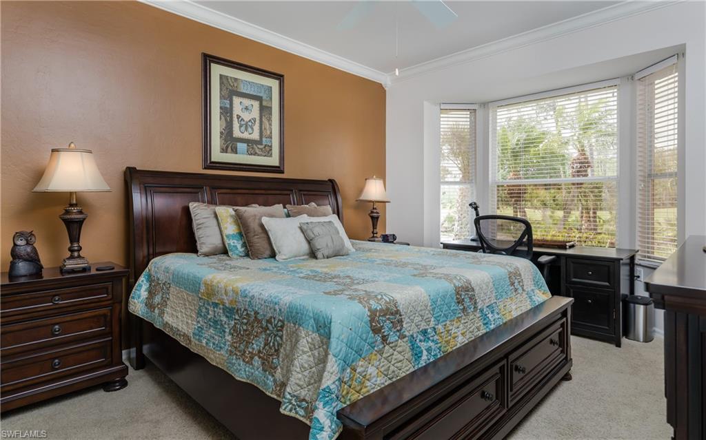 21468 Knighton Run Estero, FL 33928 - Photo 10 of 21 a bed sitting in a bedroom next to a window