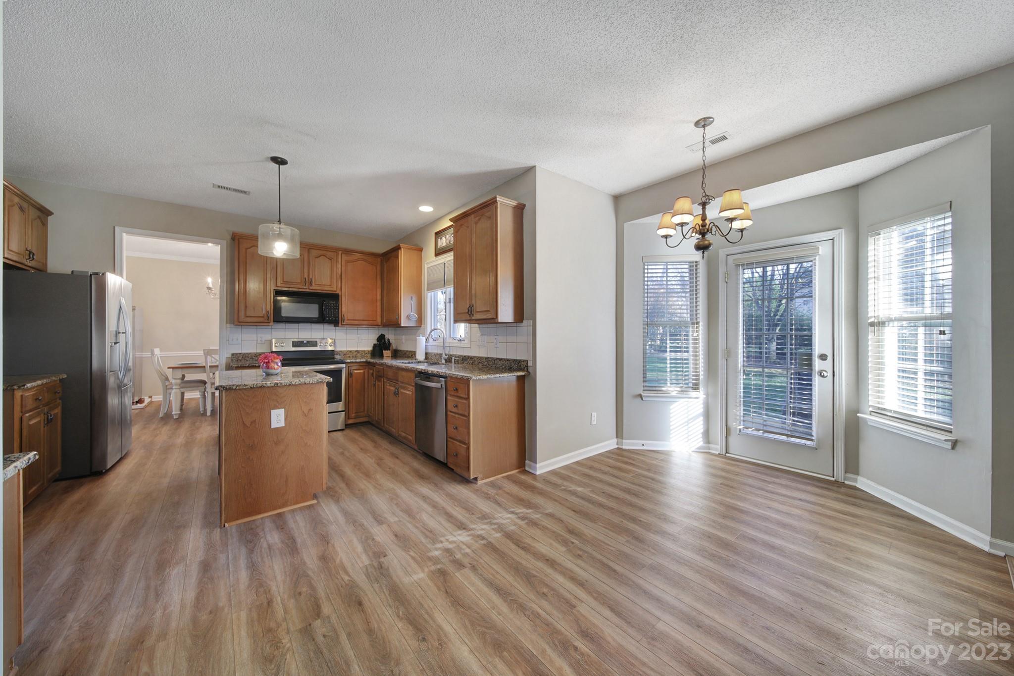 524 Whitehead Court Fort Mill, SC 29708 - Photo 12 of 45 a large kitchen with granite countertop a large counter top stainless steel appliances and cabinets