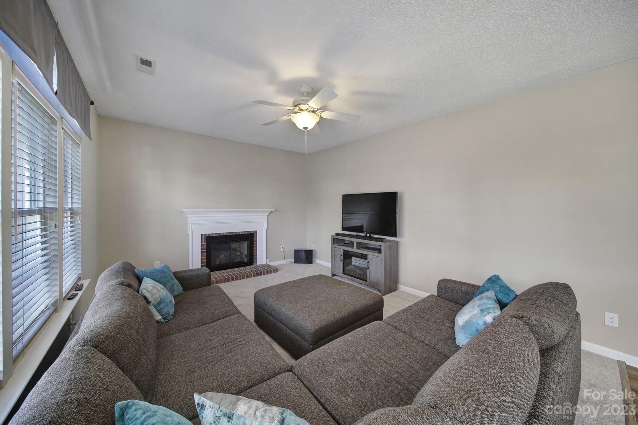 524 Whitehead Court Fort Mill, SC 29708 - Photo 15 of 45 a living room with furniture a fireplace and a flat screen tv