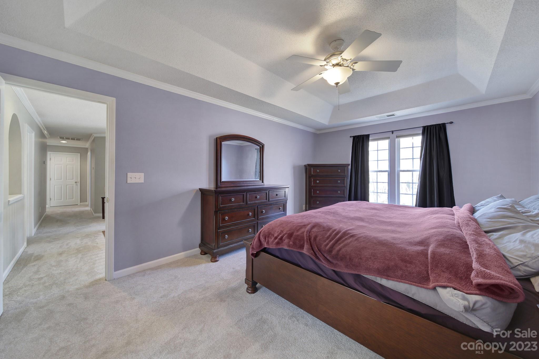 524 Whitehead Court Fort Mill, SC 29708 - Photo 19 of 45 a bedroom with a bed and a chandelier