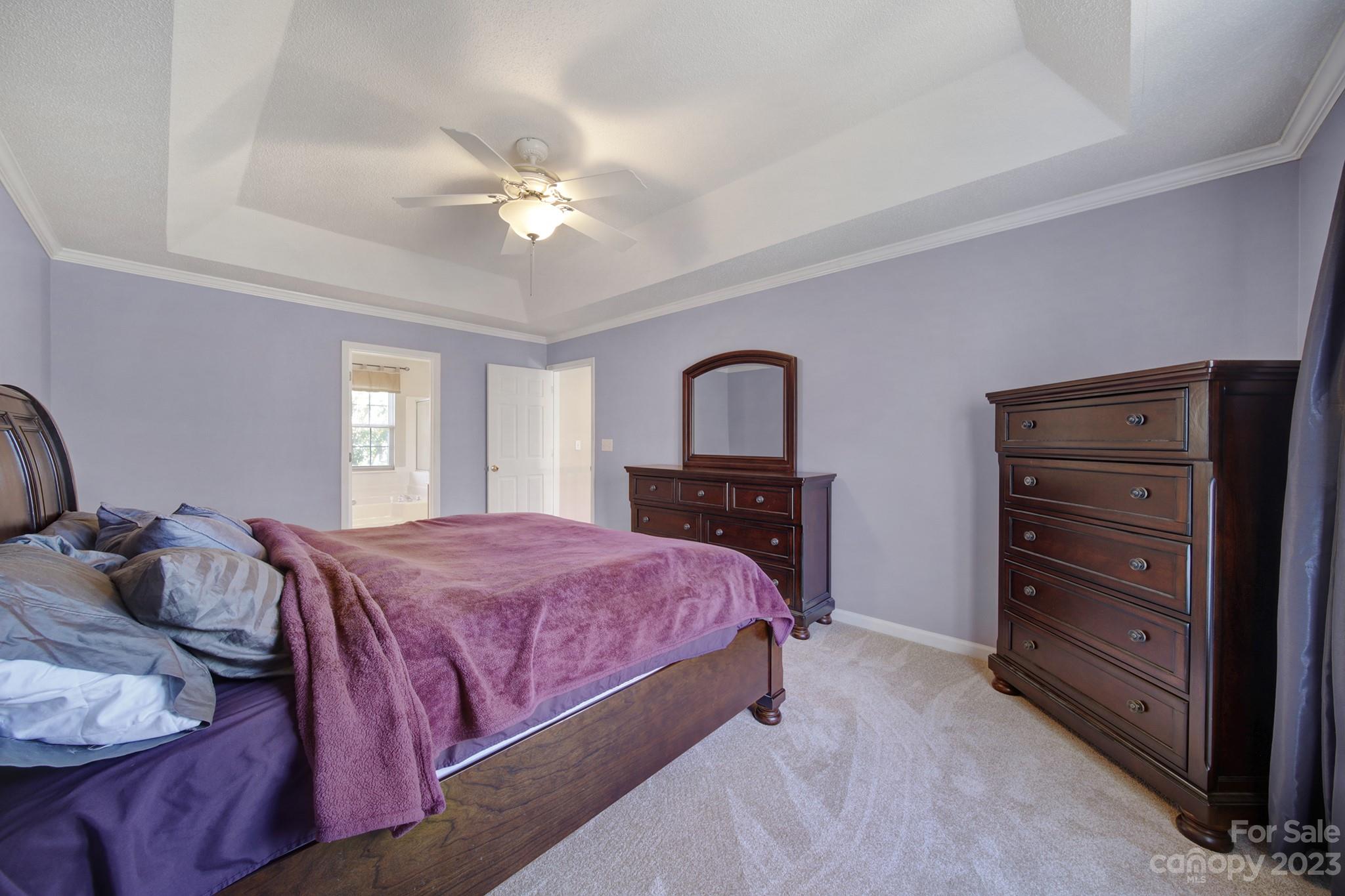 524 Whitehead Court Fort Mill, SC 29708 - Photo 21 of 45 a bedroom with a bed and a chandelier