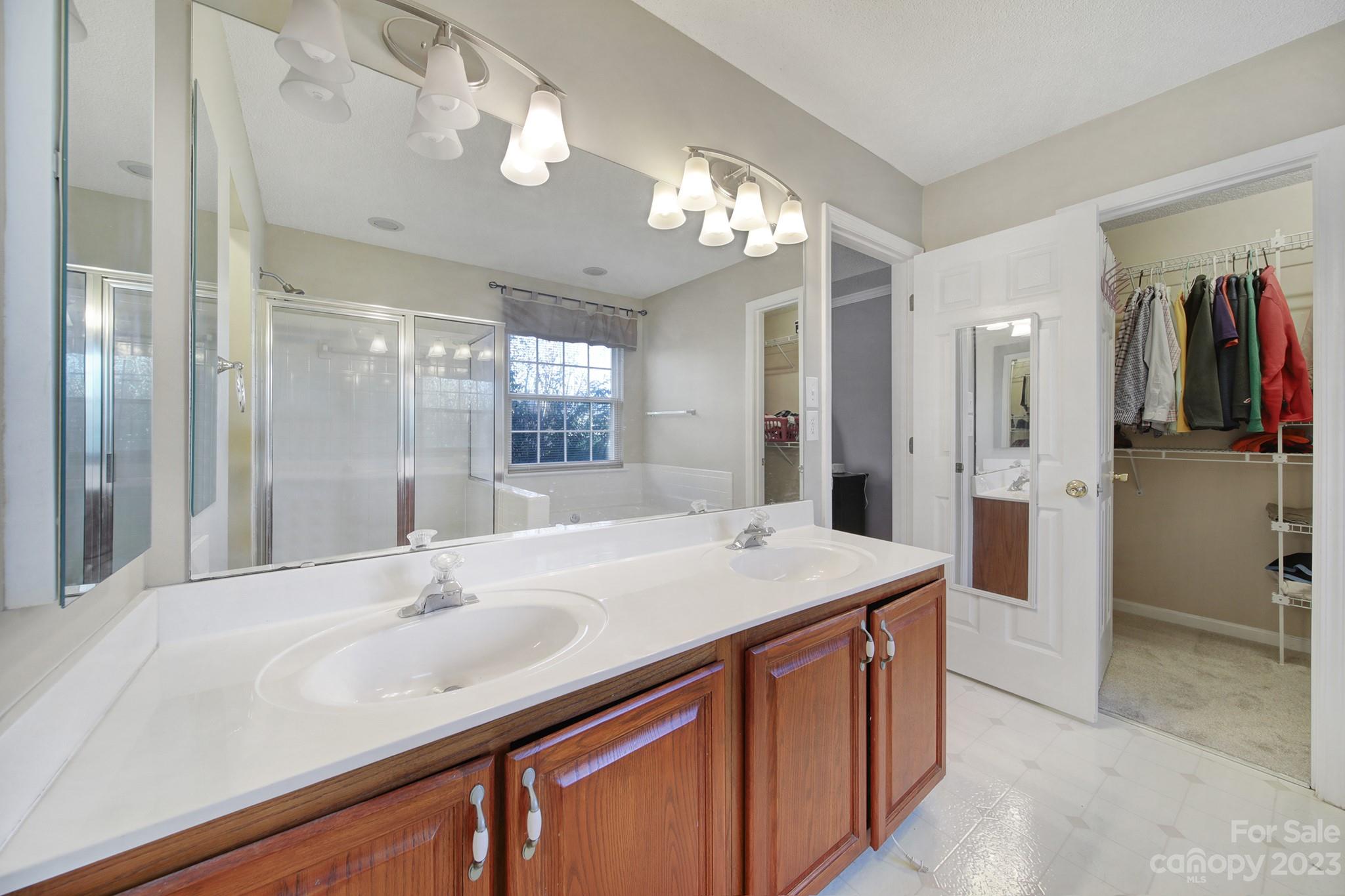 524 Whitehead Court Fort Mill, SC 29708 - Photo 22 of 45 a bathroom with a sink a shower and a mirror