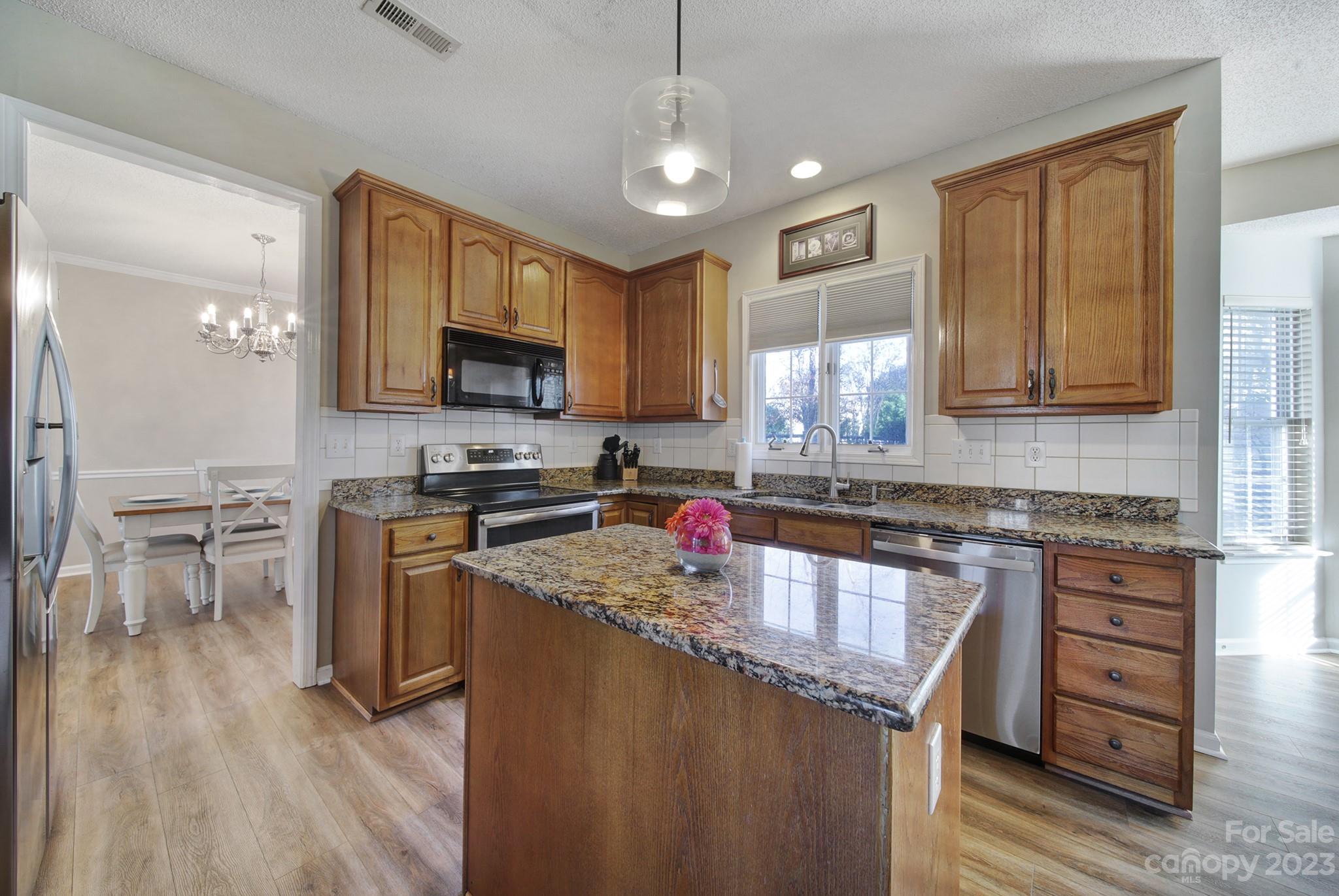 524 Whitehead Court Fort Mill, SC 29708 - Photo 8 of 45 a kitchen with stainless steel appliances granite countertop a stove sink microwave and cabinets