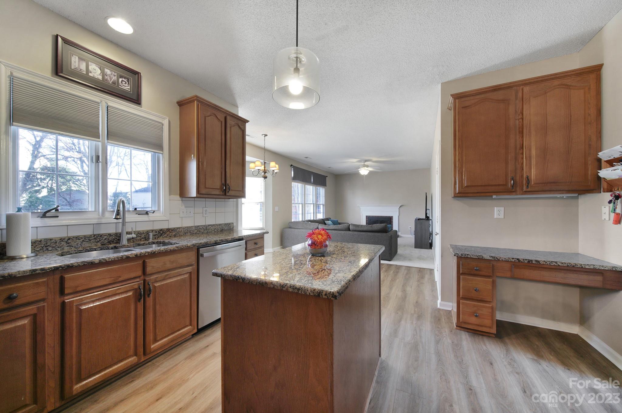 524 Whitehead Court Fort Mill, SC 29708 - Photo 10 of 45 a kitchen with stainless steel appliances granite countertop wooden cabinets a sink dishwasher a stove and a refrigerator with wooden floor