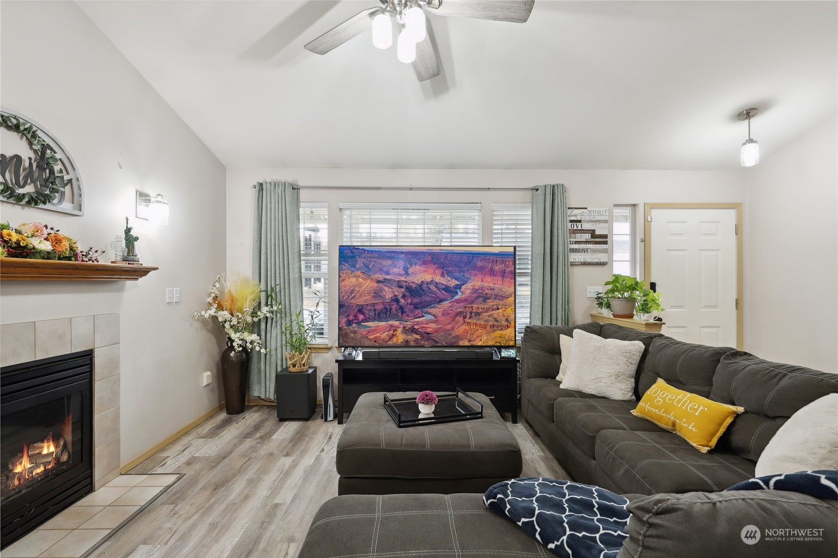 2977 Lowren Loop Port Orchard, WA 98366 - Photo 6 of 33 a living room with furniture a fireplace and a flat screen tv