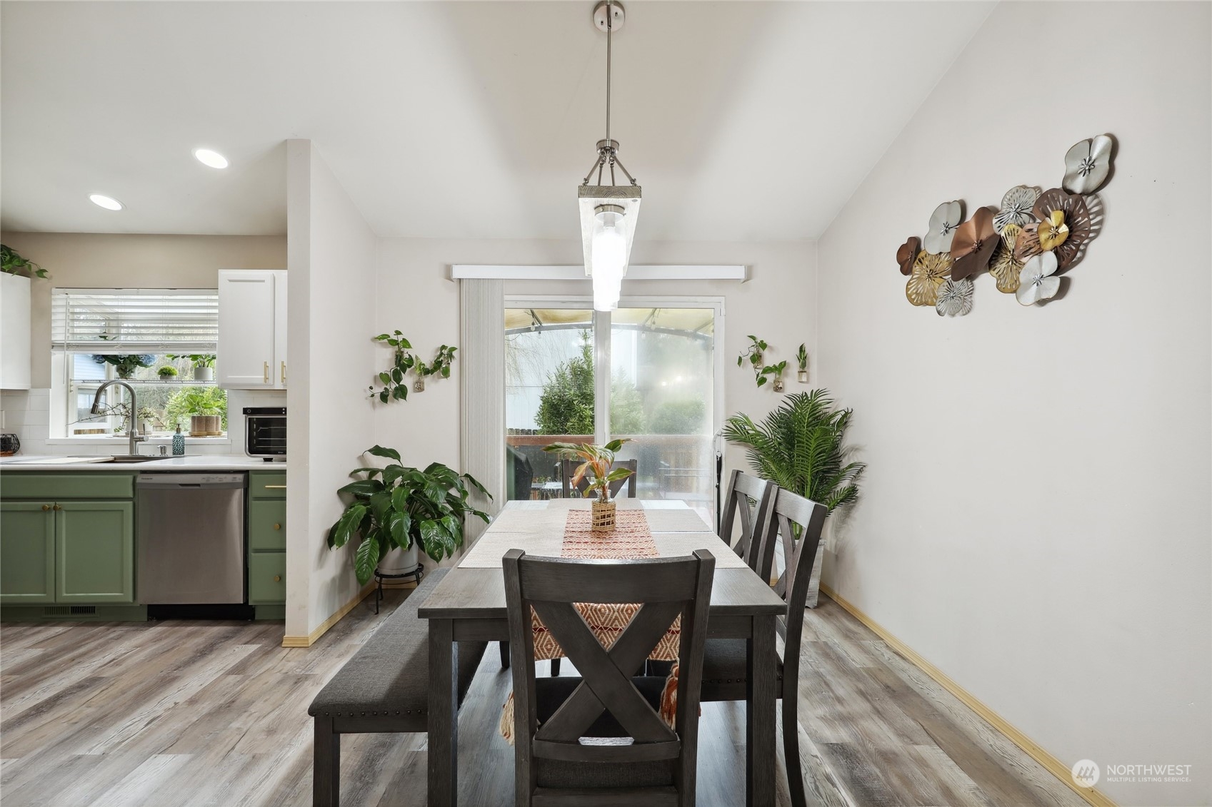 2977 Lowren Loop Port Orchard, WA 98366 - Photo 8 of 33 a dining room with furniture potted plants and wooden floor