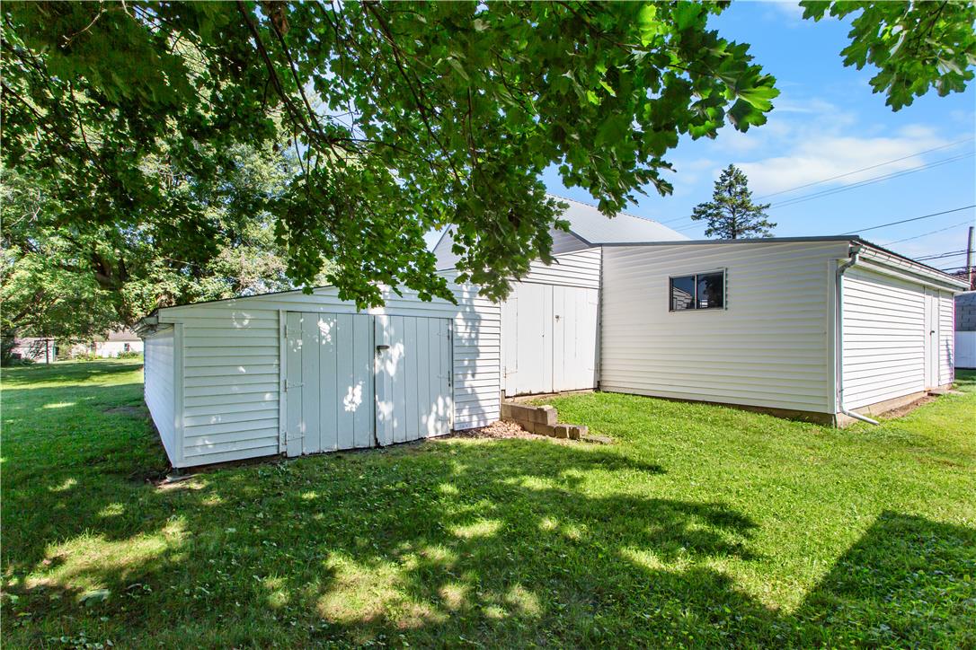 479 Cherry Hill Road Nazareth, PA 18064 - Photo 21 of 25 Mature trees shade a grassy lawn surrounding a white outbuilding with vinyl siding.