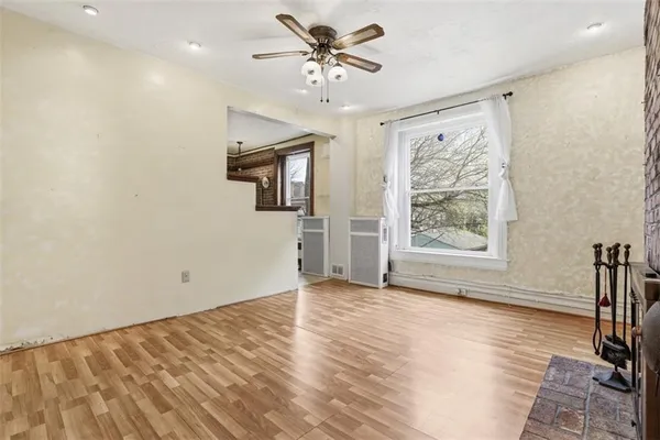 wooden floor in an empty room with a window