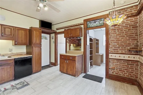 a kitchen with granite countertop a refrigerator and a stove top oven